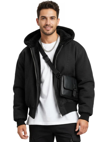 Man wearing a black hooded canvas short jacket and carrying a black bag on a white background